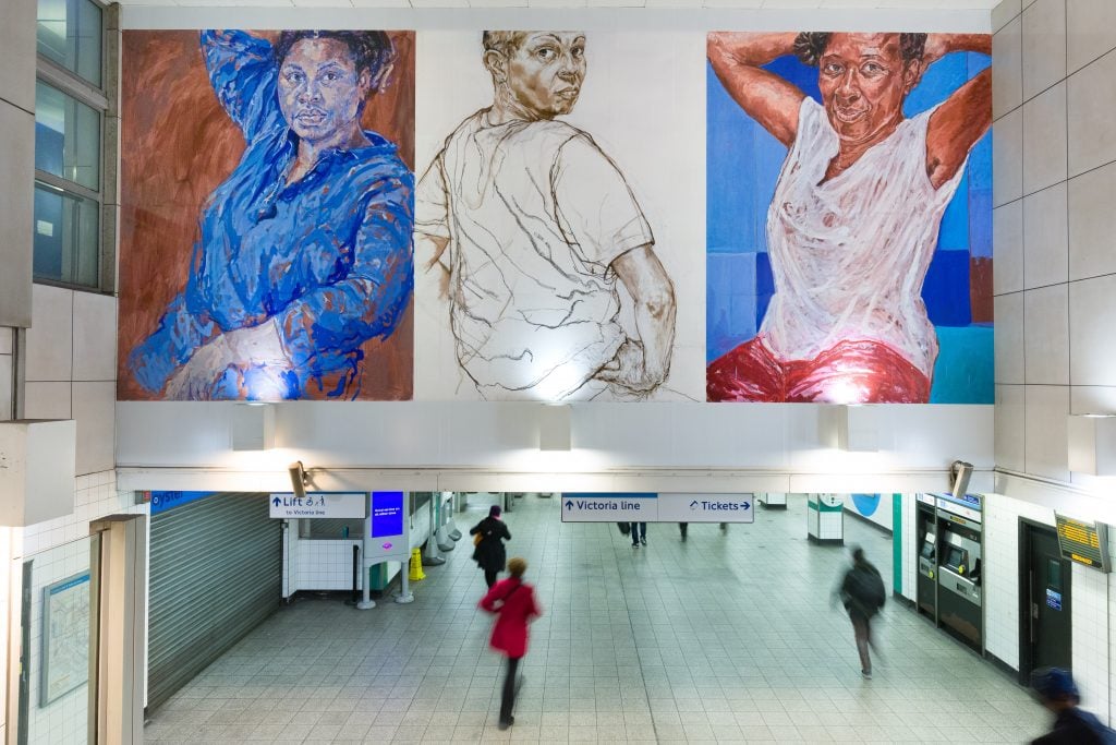 A mural of three women at a station in London