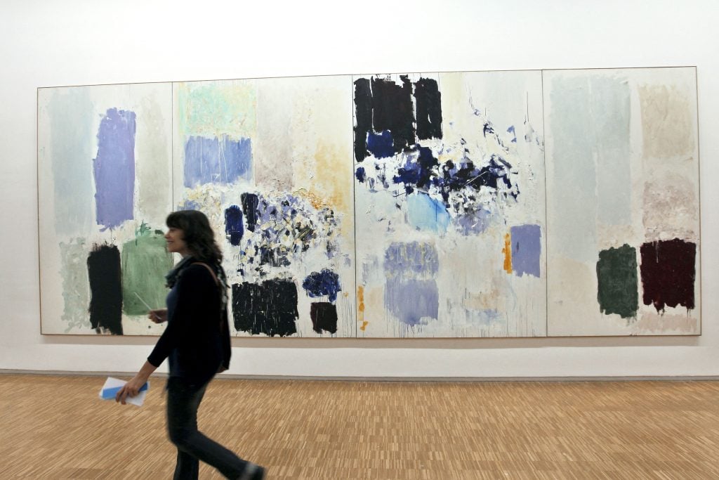 A woman passes in front of Joan Mitchell's 1973 painting Chasse interdite (Forbiden Hunt) at the Musée national d’art moderne at the Centre Pompidou in Paris in 2011.