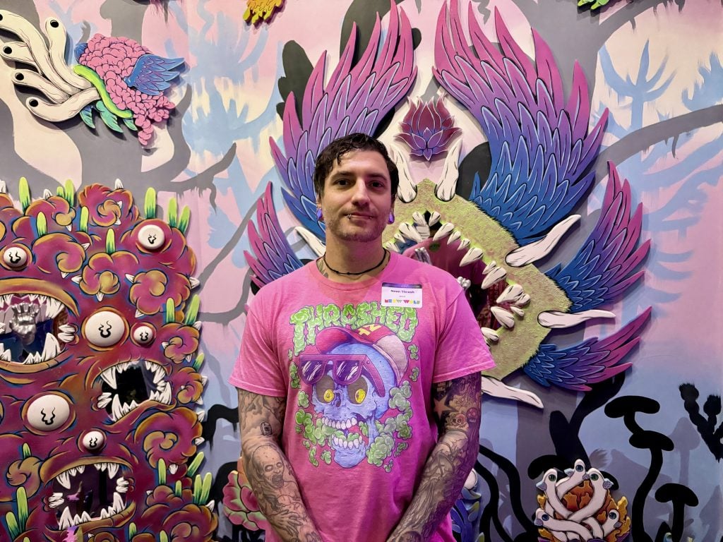 Houston artist Brian Dibala, known as Neon Thrash, with his Meow Wolf Radio Tave installation.