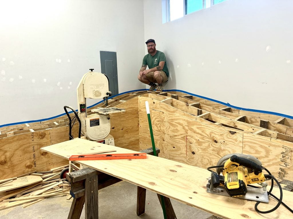 Patrick Renner with an interactive art installation he is building in Houston.