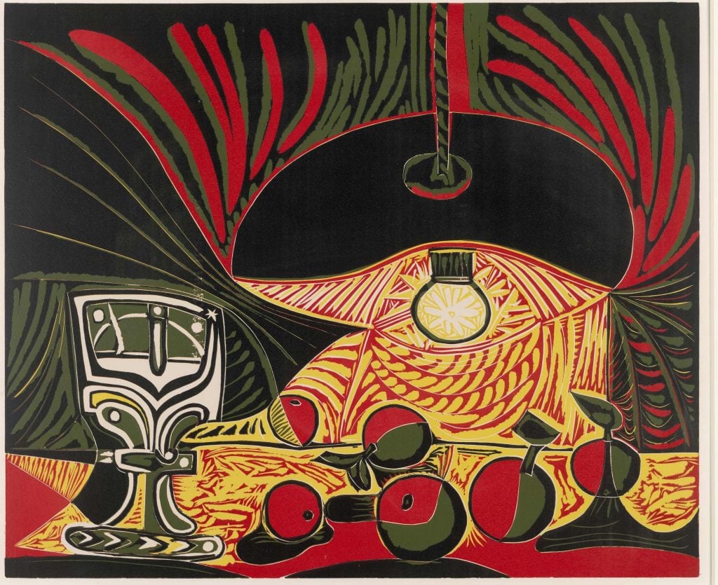 Vibrant still life featuring a lamp illuminating a table with a goblet, apples, and abstract patterns in bold reds, greens, and yellows