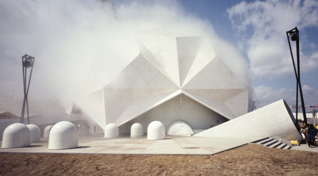 A large geodesic dome emitting fog