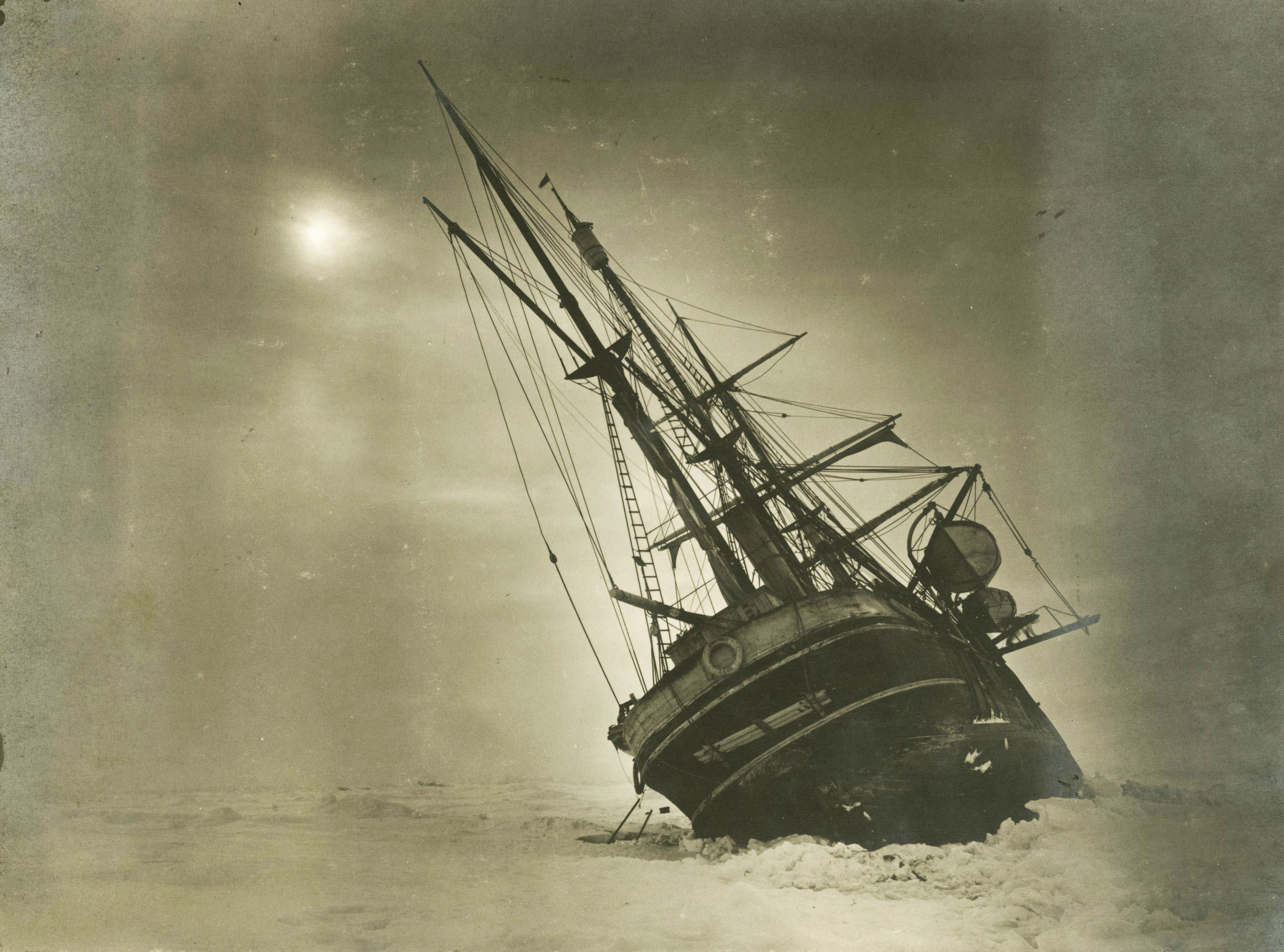 A ship leaning to one side in ice