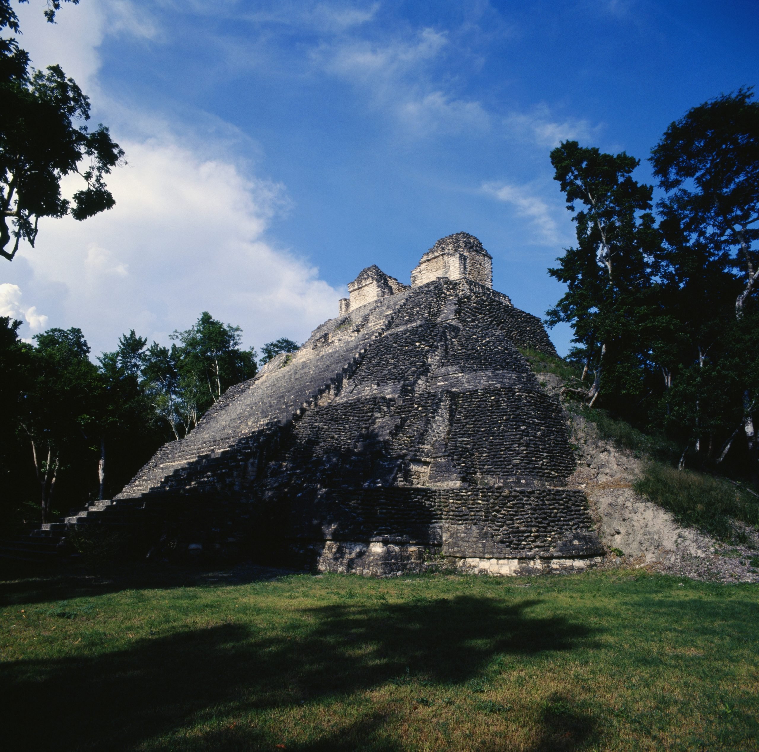 a view to a staggered temple with trees on the side