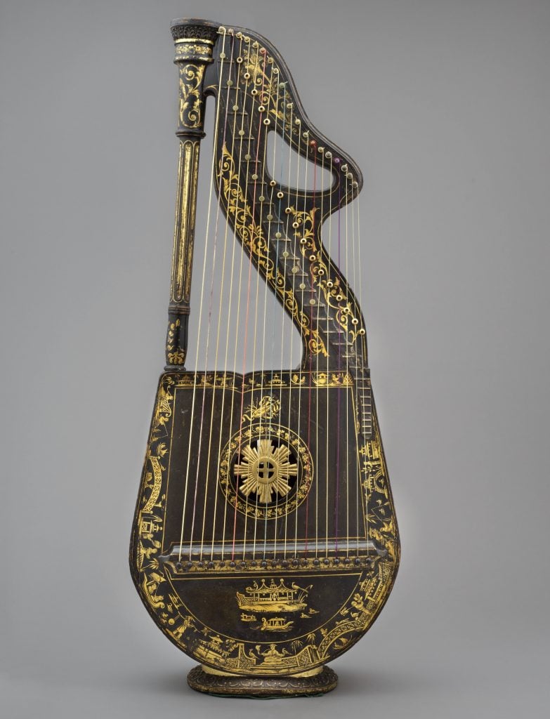 an elaborately decorated antique harp