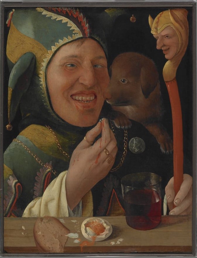 A detailed painting of a grinning jester in colorful attire, holding a staff topped with a small figure, alongside a dog and a meal of bread, a soft-boiled egg, and a glass of wine.