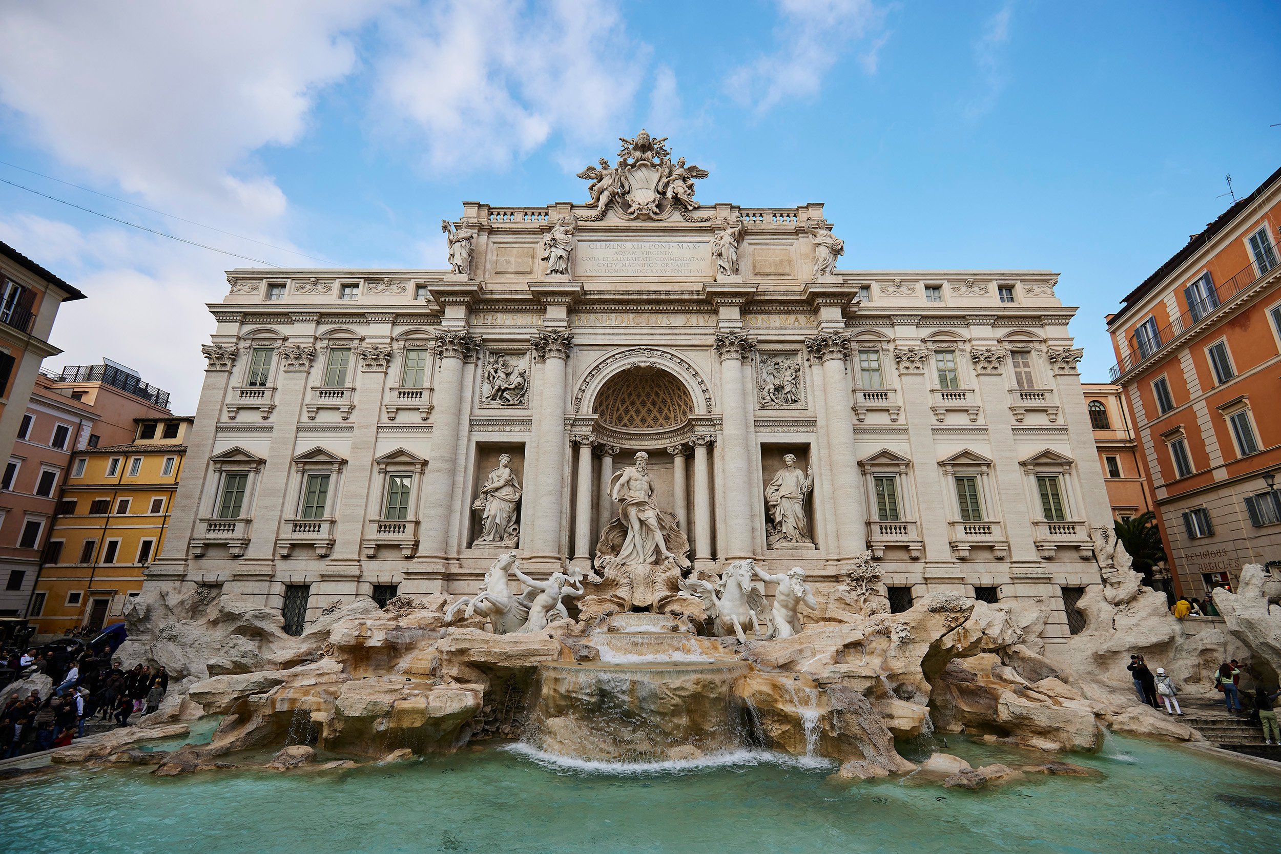 Trevi Fountain in Rome, showcasing its grand architecture and intricate sculptures set against a clear sky