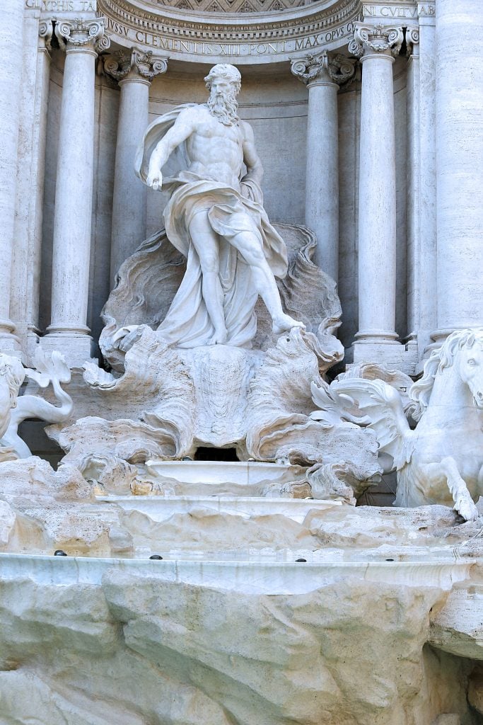 Close-up of a central statue in Rome’s Trevi Fountain, highlighting its detailed carvings and craftsmanship