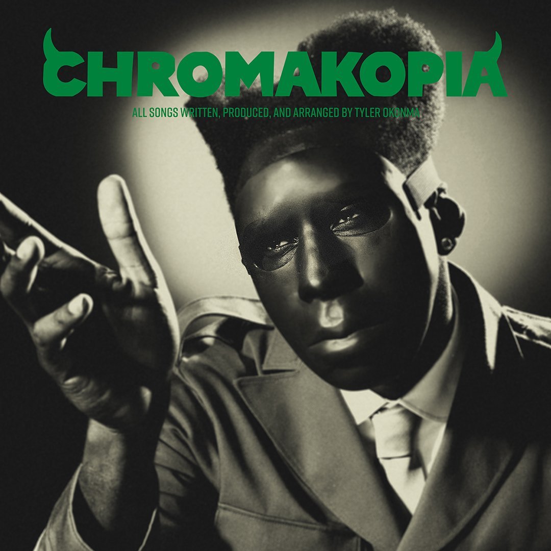 A man wearing a full-face mask posing with his hand outstretched, under the title "Chromakopia"