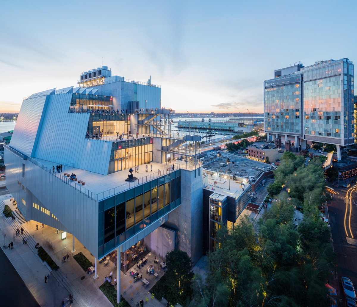 Aerial view of the Whitney Museum in New York, showing a glass and steel structure surrounded by trees