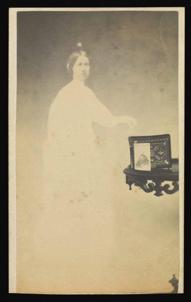 A double exposure photo showing a photo frame on a shelf, overlaid with a white figure of a woman