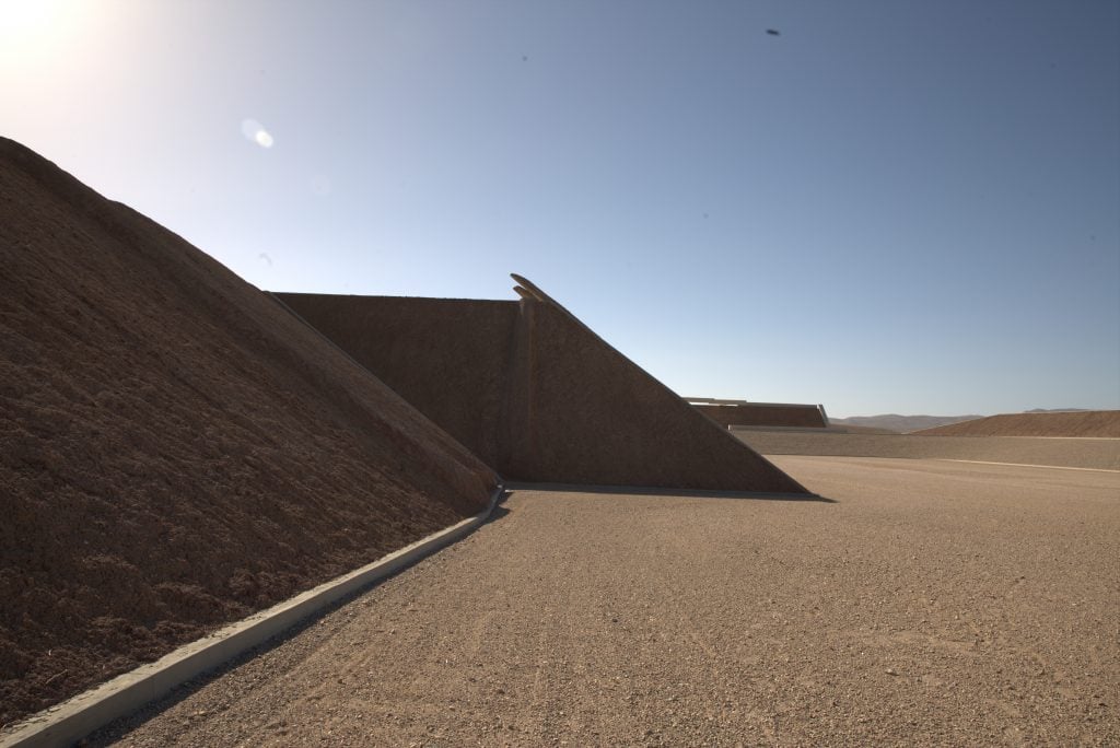 a shadowy view of two monolithic sculptures 