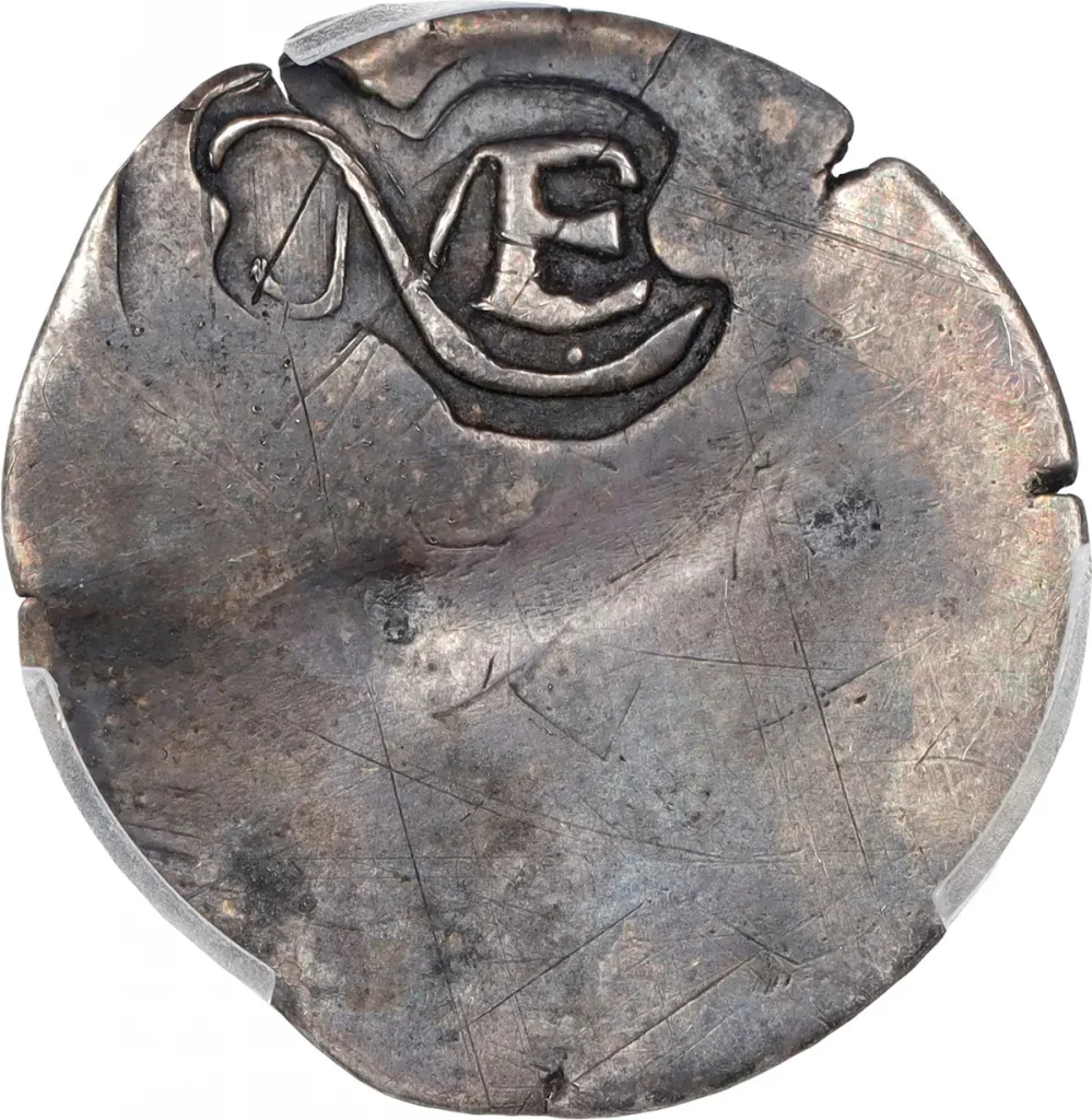 A close up photograph of the 1652 silver threepence coin emblazoned up top with 'NE' on a white background.