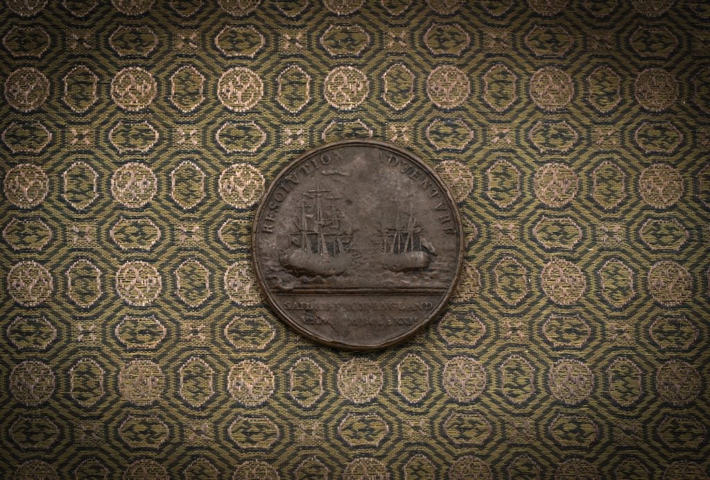 a large medal on a pattern cloth background