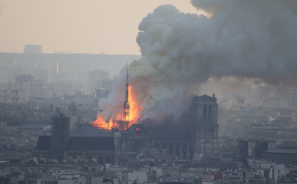 flames and smoke plumes out of a church