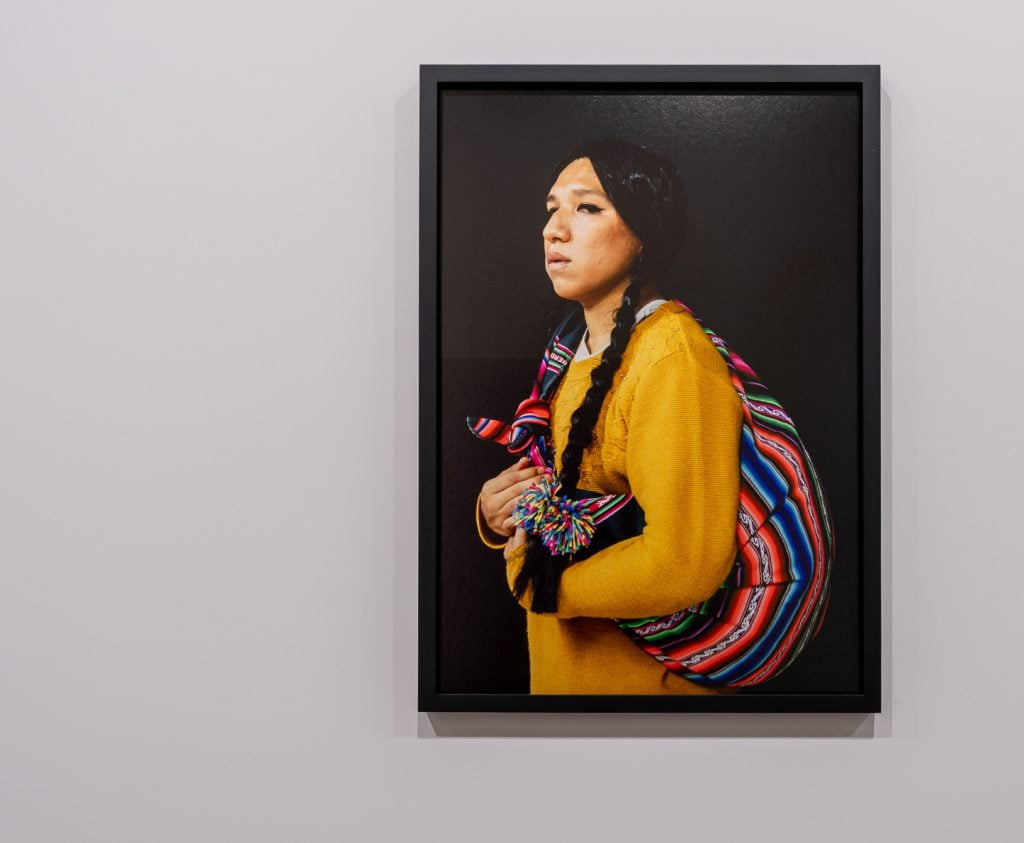 a figure in native dress looks at the view in an art photograph