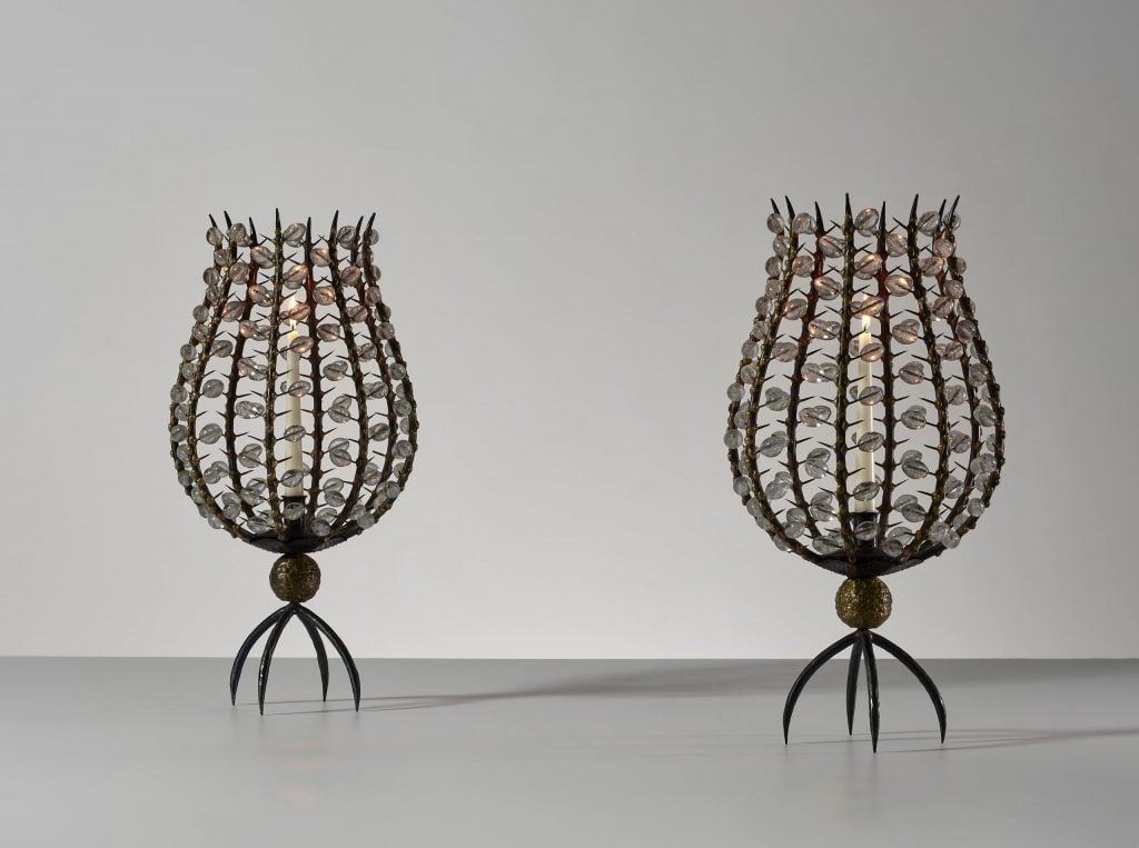 two intricate glass and iron candleholders 