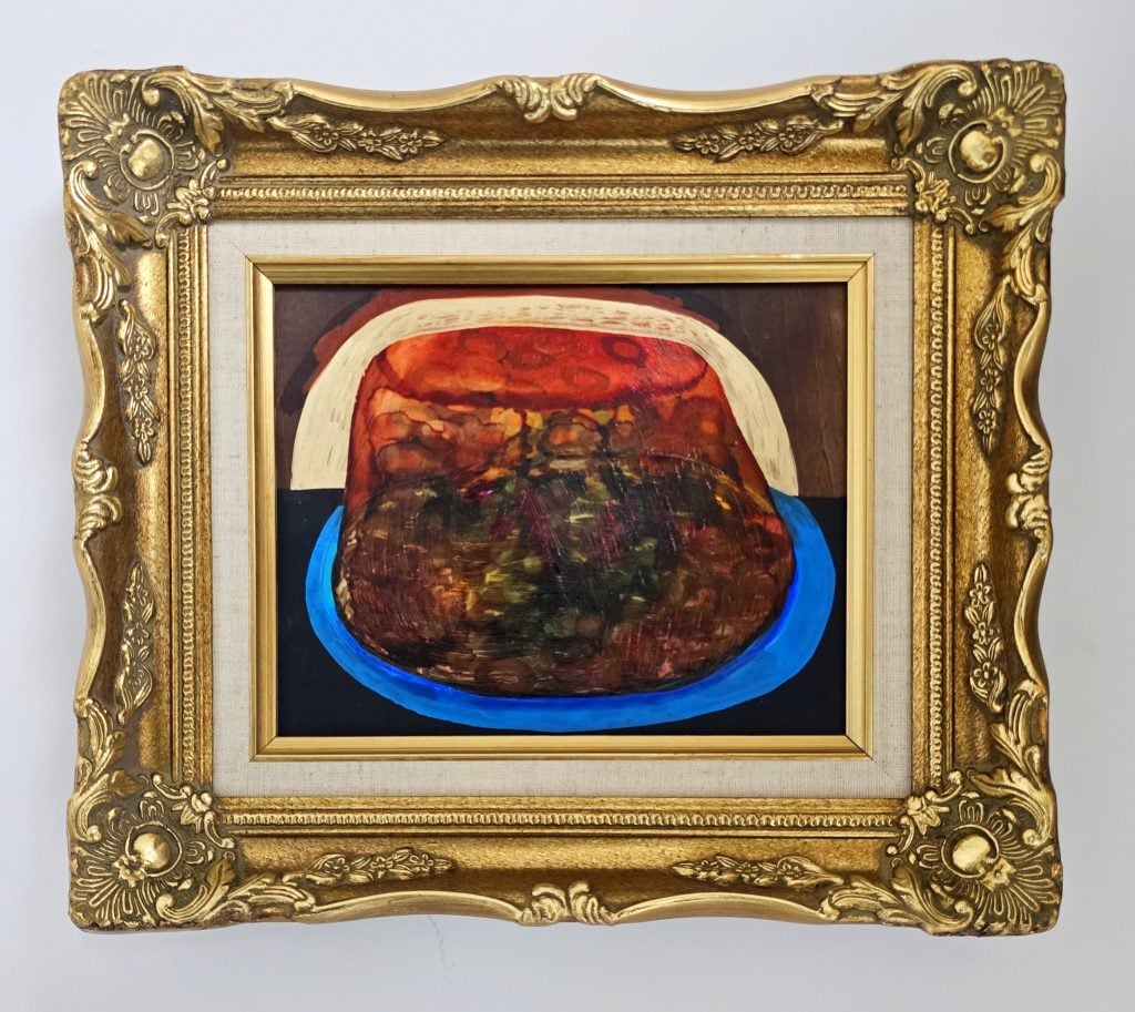 A painting by Azikiwe Mohammed. It is a red molded Jell-O dessert in an ornate gold frame. 