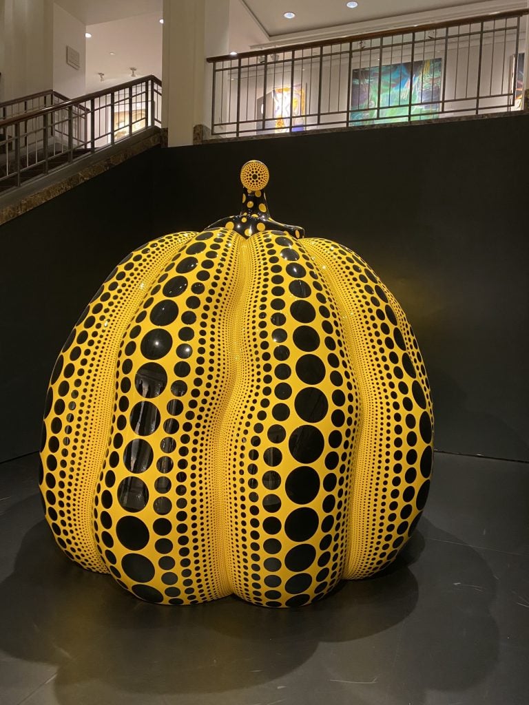 a giant yellow pumpkin covered in black dots at Christie's