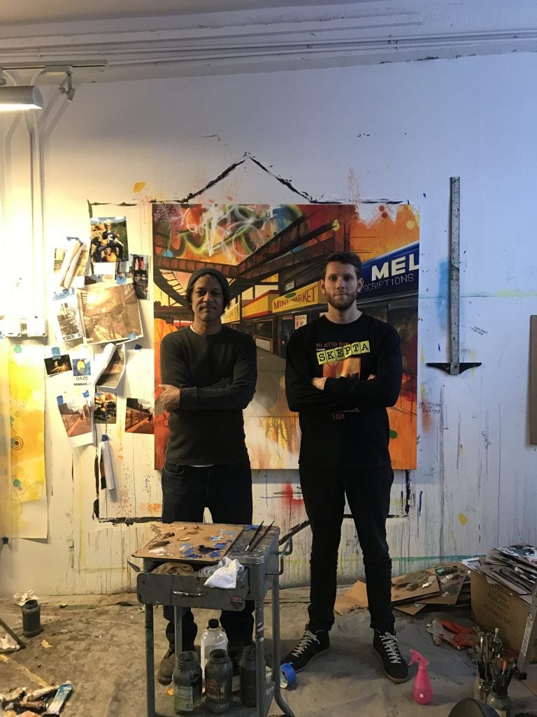 Dark Green founder Michael Doohan standing to the left of graffiti artist DAZE in the artist's studio.