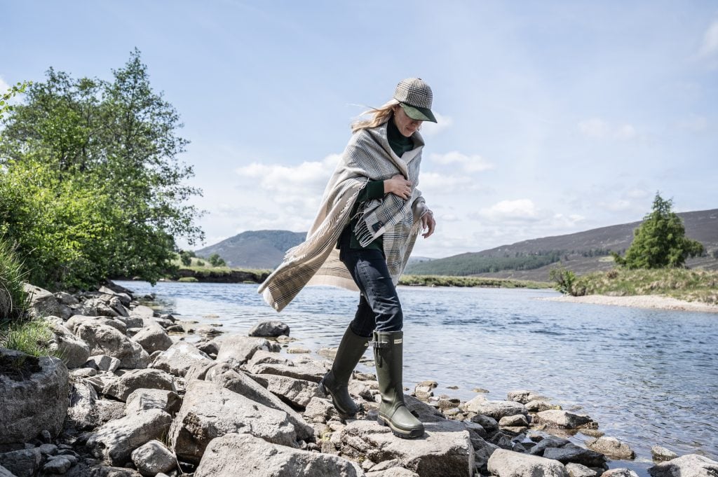 a woman walks along a river