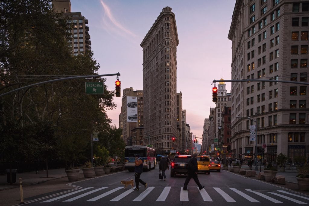 a color photograph of the iconic flatiron building, a wedge shaped architectural structure