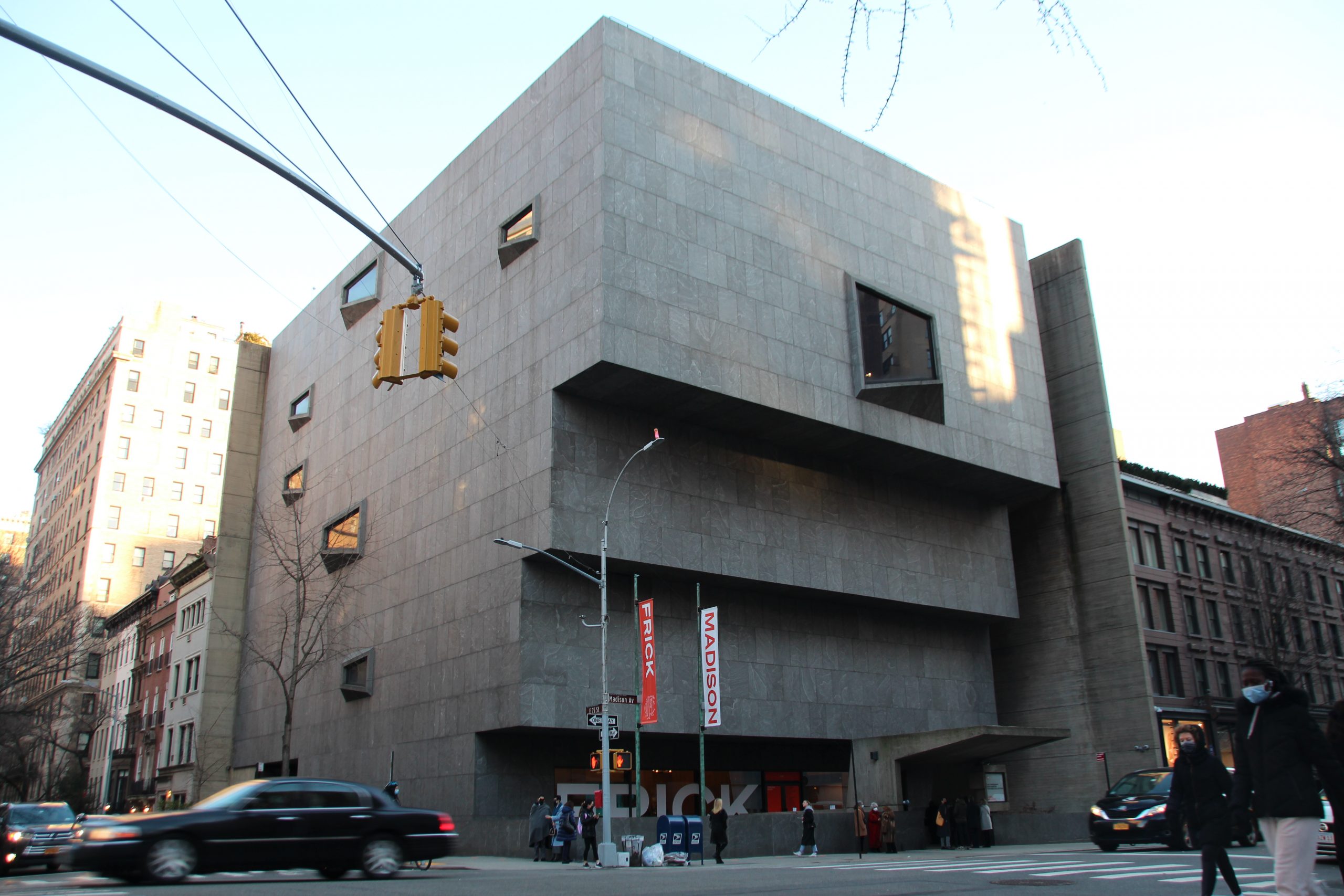 a large grey modern building on a new york street corner