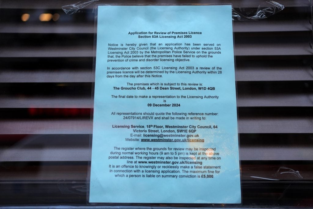 a white piece of paper with typed text is posted in a window