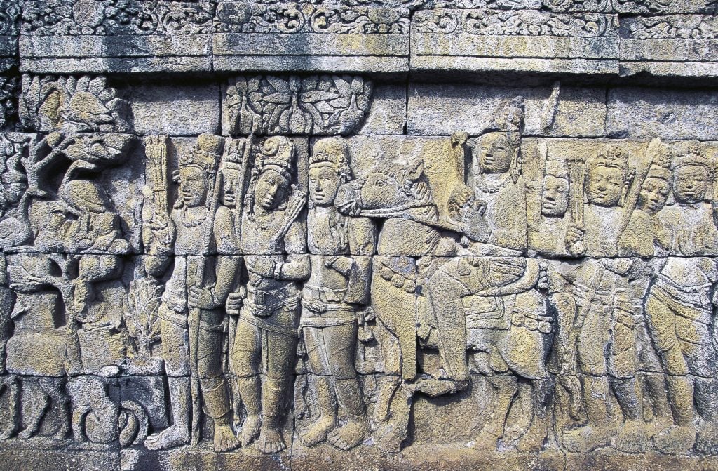 a relief carving in stone depicting a row of people