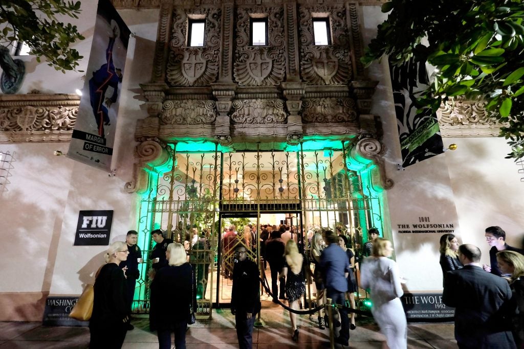 Guests arriving at the Wolfsonian FIU Vanity Fair Art Basel Miami Beach Celebration at Wolfsonian on December 4, 2015 in Miami Beach, Florida. There is a crowd at night outside the Art Deco building. 