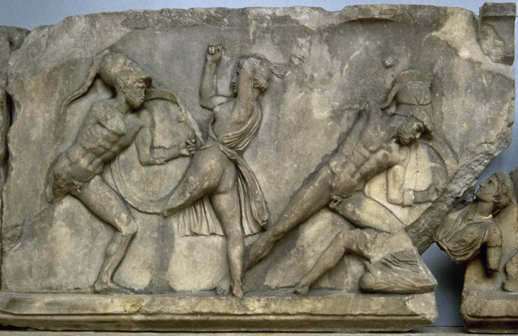 A frieze carved from marble depicting a battle between ancient Greeks and Amazons. 