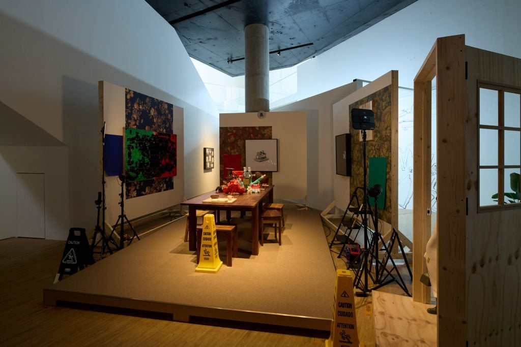 A room surrounded by panels and a dining table sitting in the middle