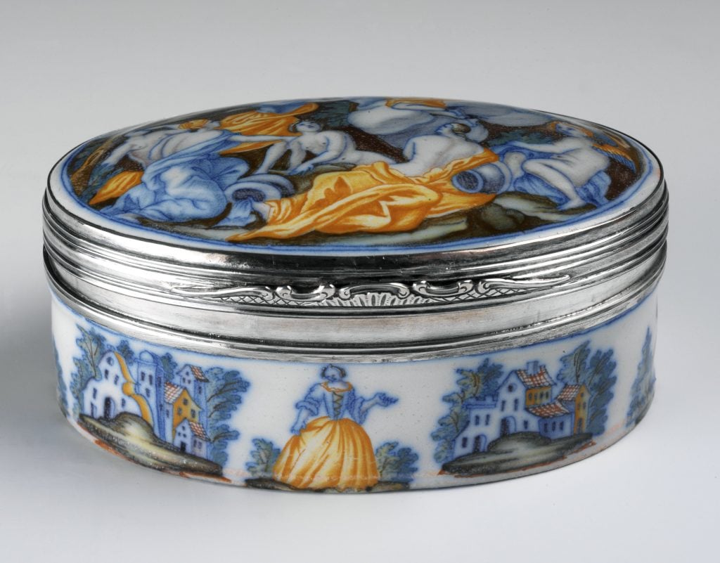 a colorful snuff box depicts a country scene 