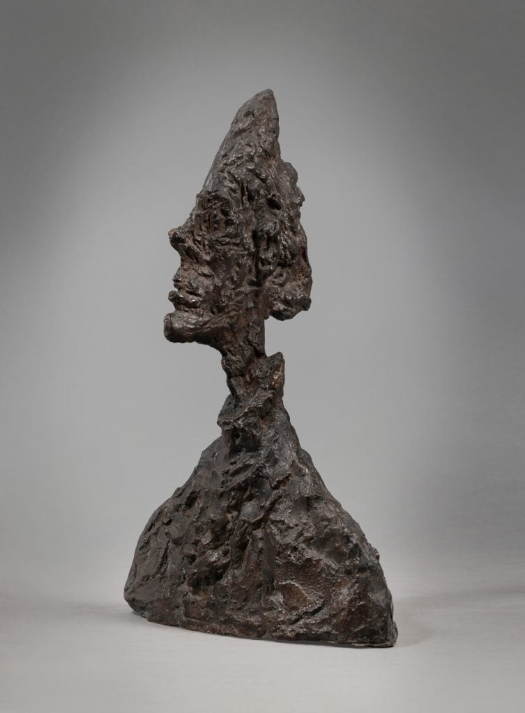 A photo of a dark-color, abstract sculpture of a head