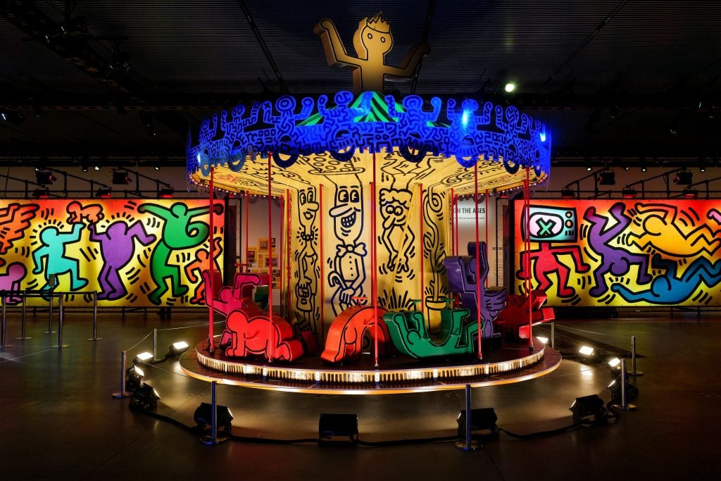 an illuminated carousel is covered in figurative Pop art 