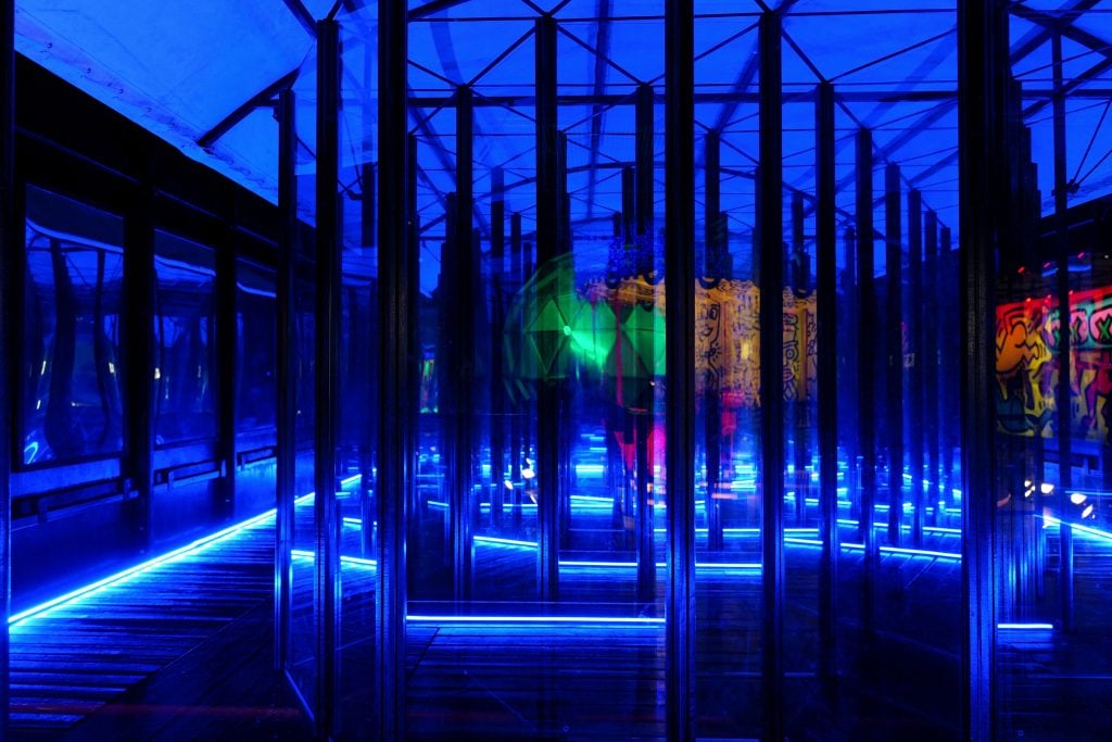 blue neon lights illuminate an artistic fun fair 