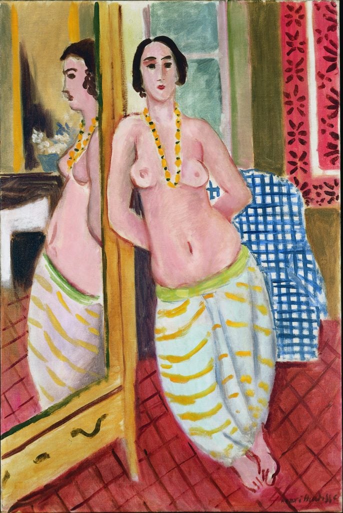 painting of a woman with bare chest in baggy striped pants standing on a white floor next to a large mirror with a blue cloth in the background