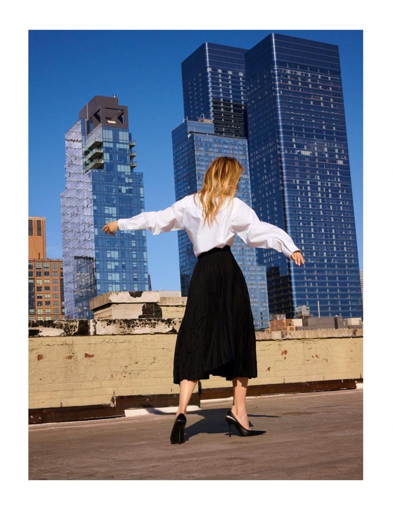 Nicole Kidman walking away from the camera photographed against the Manhattan sky line.