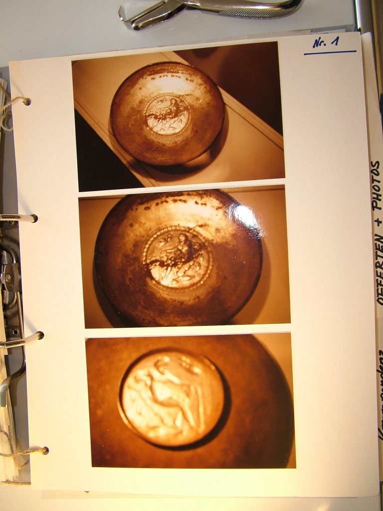 A page of a document showing three images of a silver plate, but the photos look yellowed and blurred