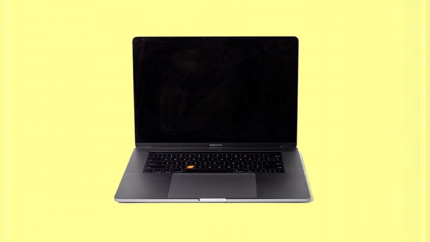 a laptop is set in the middle of a yellow background