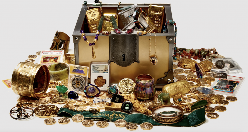 a photograph of a treasure chest with gold coins nad precious objects spilling out