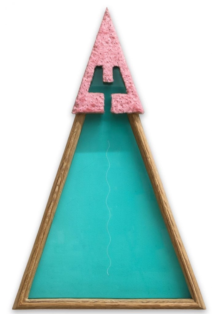 a triangular sculpture is turquoise with a pink cap 