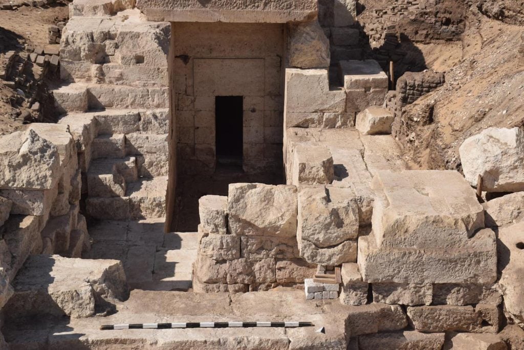 The entrance of an ancient egyptian temple with a tall rectangular opening.