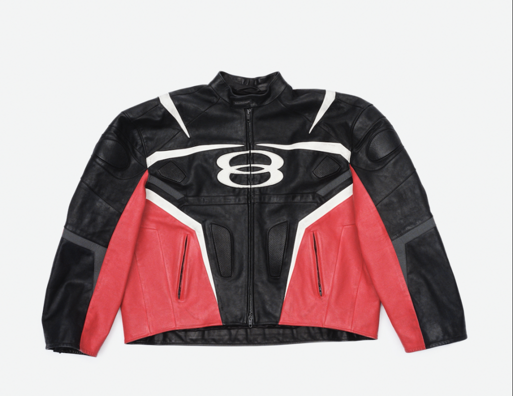 A photograph of a red and black racing jacket with the Balenciaga Unity logo on it.