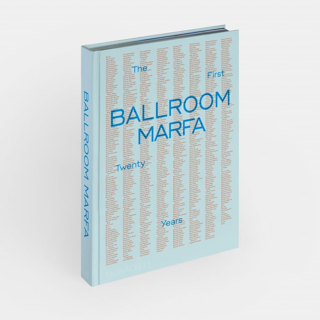 A photograph of a light blue book with orange fine print on it and a dark blue title reading "BALLROOM MARFA"