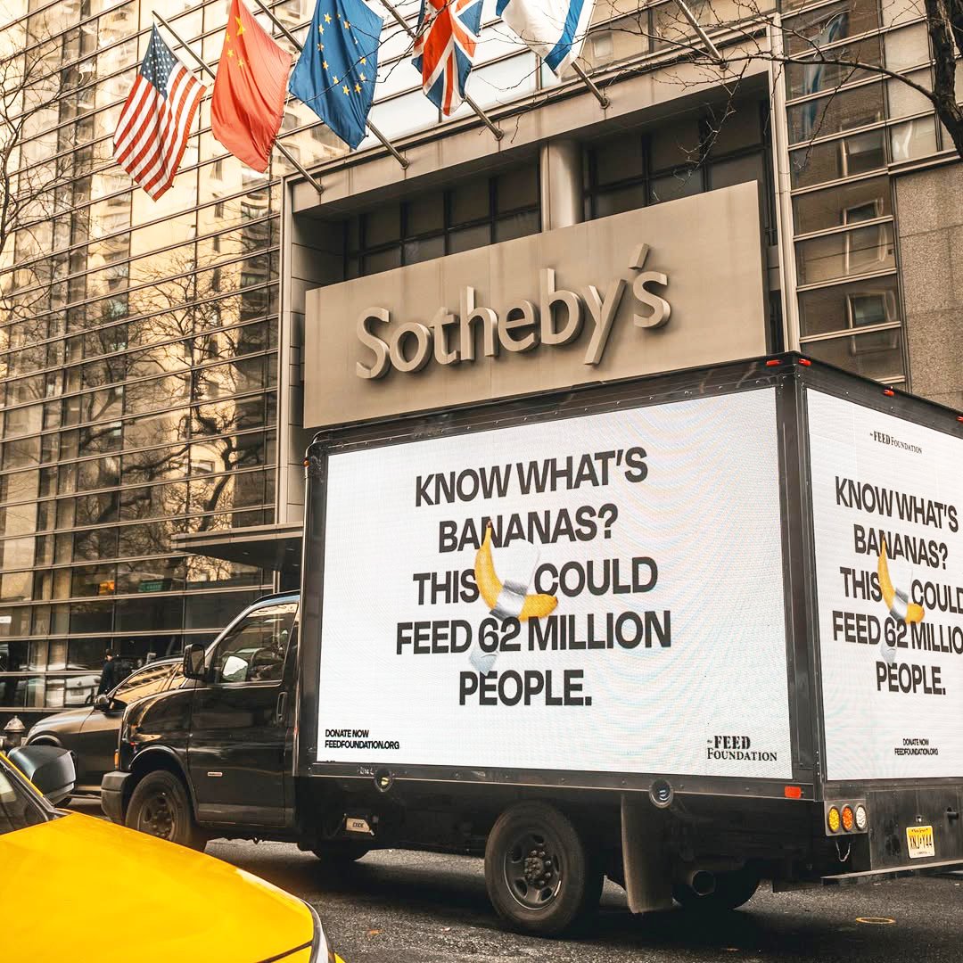 Protesters outside Sotheby's in response to the artwork 'Comedian'.