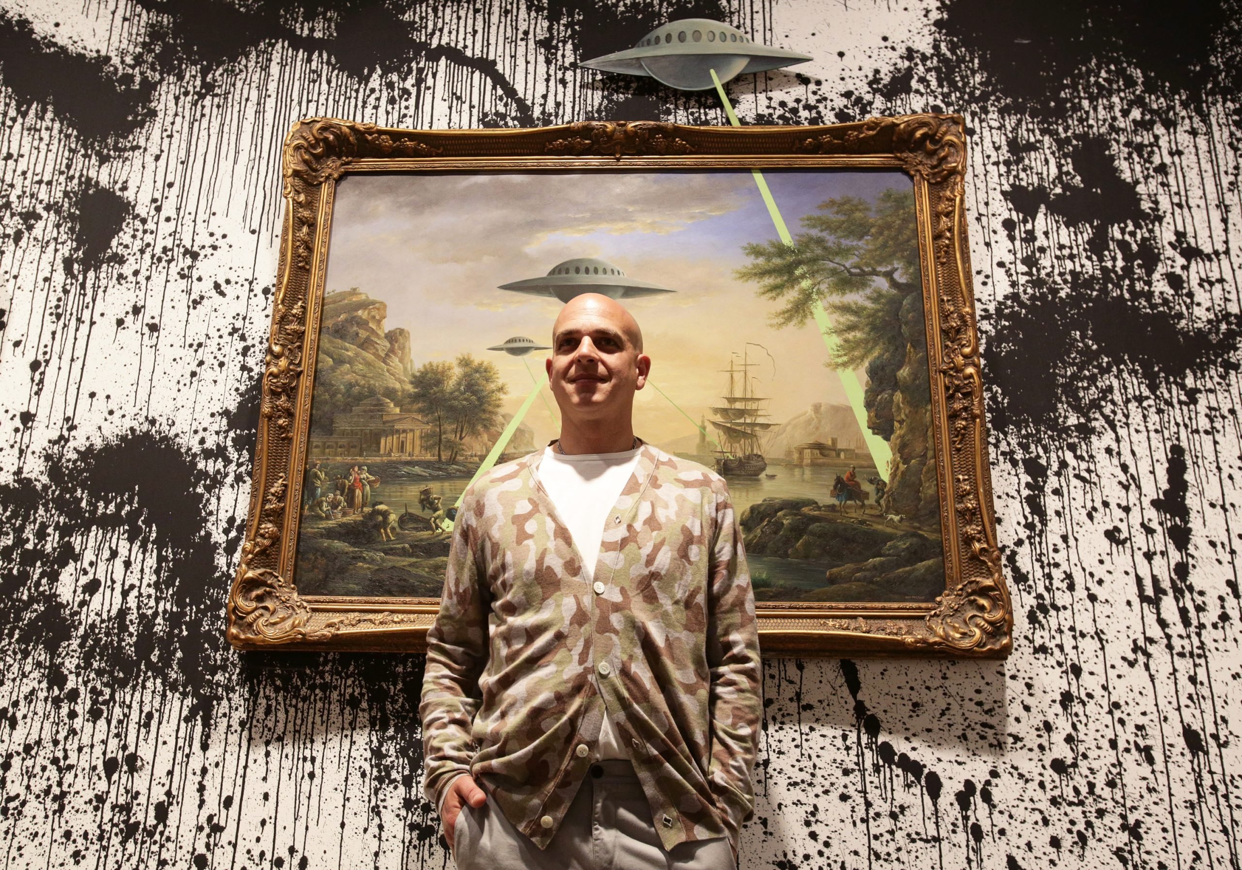 Curator Steve Lazarides posing in front of Banksy's painting