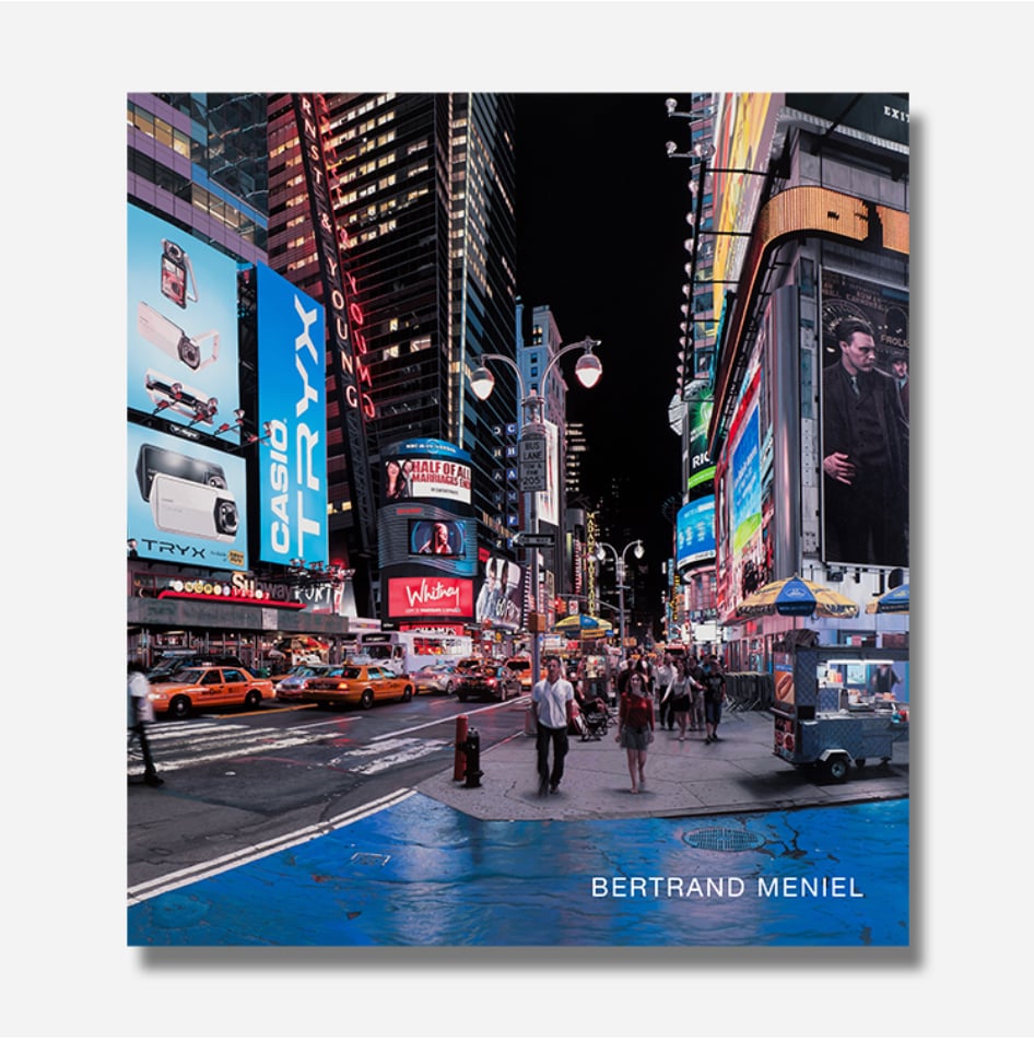 Cover of a book titled Bertrand Meniel: Paintings, 1996–2024 with a reproduction of a photorealistic painting by the artist of Time's Square at night.