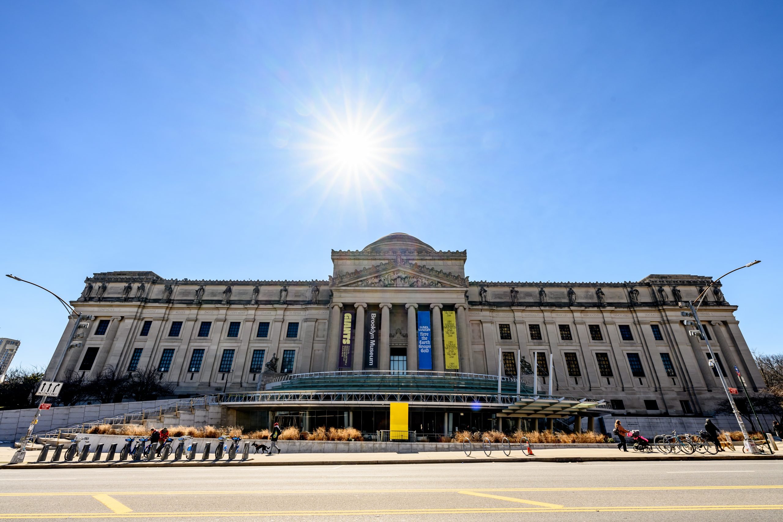 Exterior shot of the Brooklyn Museum, a Beaux Arts-style building with a glass front