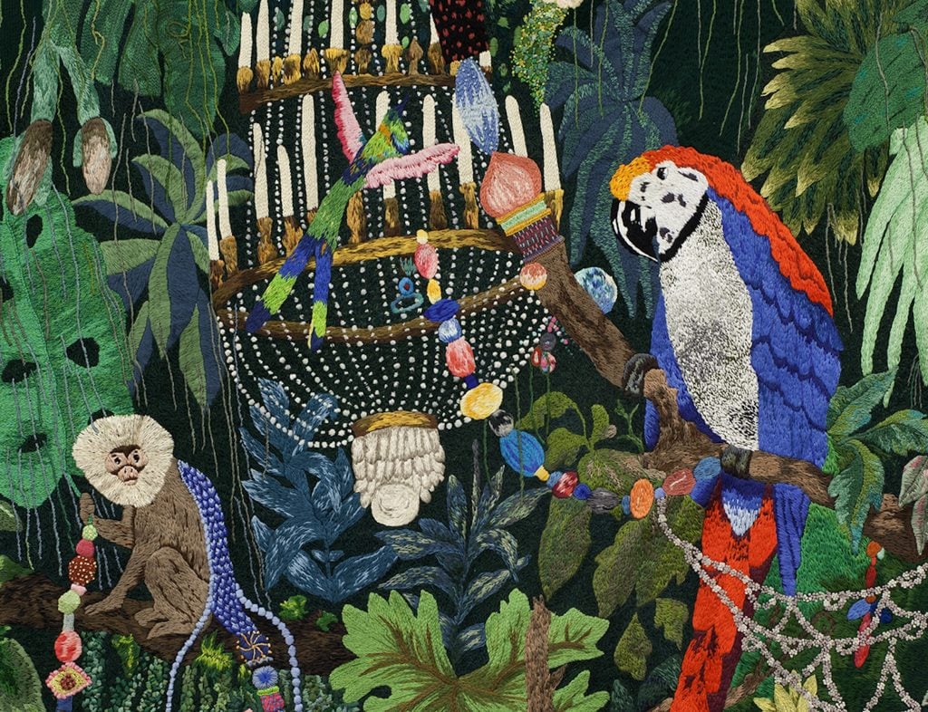 A fabric work of art showing animals in a jungle setting on view at Art Basel Miami Beach